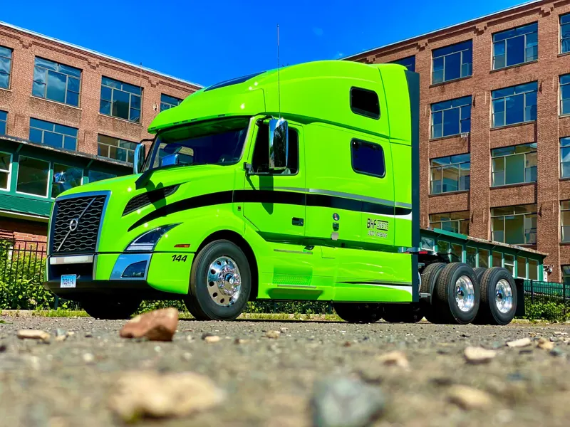 Green Volvo truck, unit 144